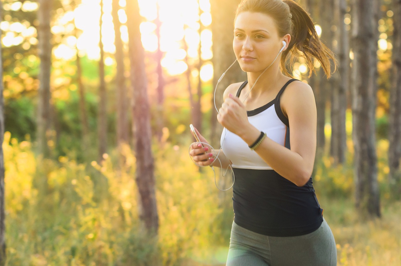 Woman jogging outdoors at golden hour — inspired weight-loss progress
